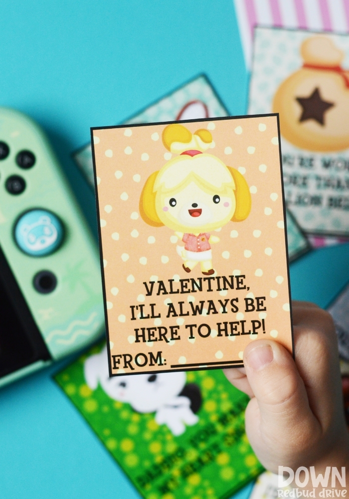 animal-crossing-valentines-main-tall-2 A tall image of a child holding a valentine that says "Valentine, I'll always be here to help!" on it.