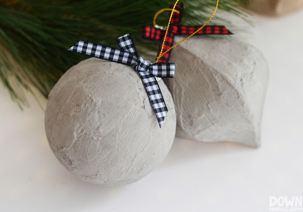 diy-concrete-christmas-ornaments-4-1 The finished DIY Concrete Christmas Ornaments with buffalo check bows.