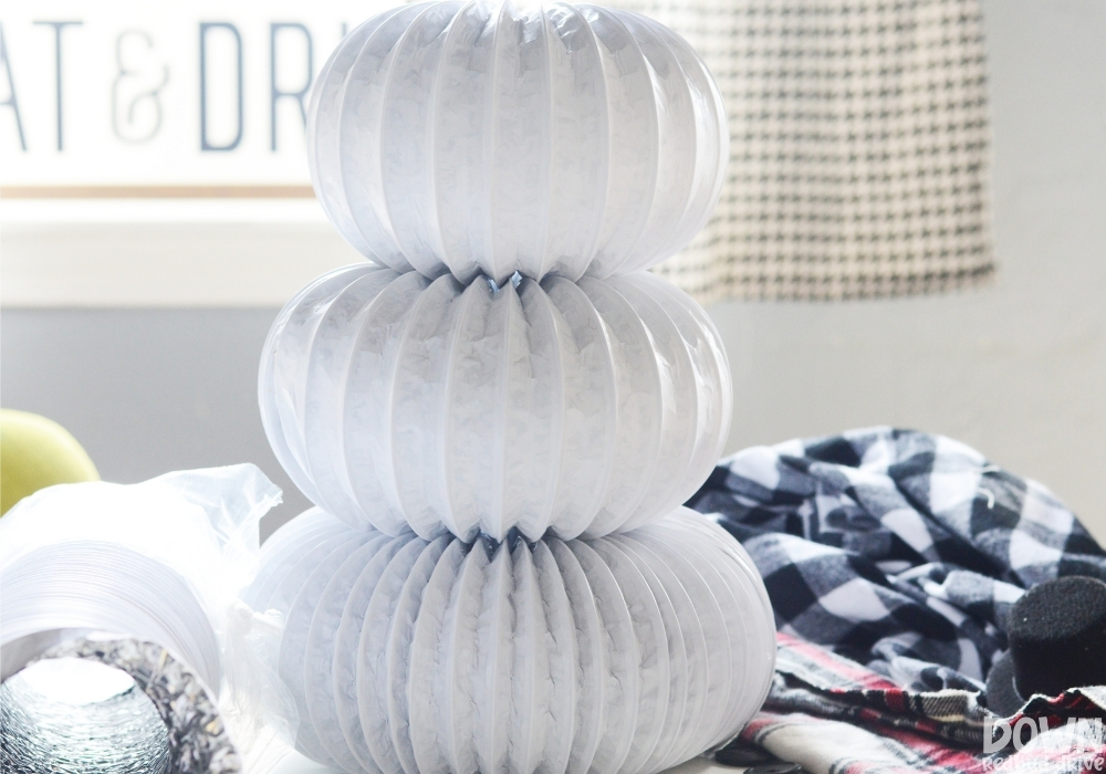 diy-dryer-vent-snowman-wide-6 The three different sizes of white dryer vent duct glued together to help form the DIY Dryer Vent Snowman.