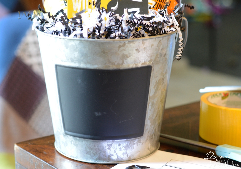galvanized bucket with a chalk board label