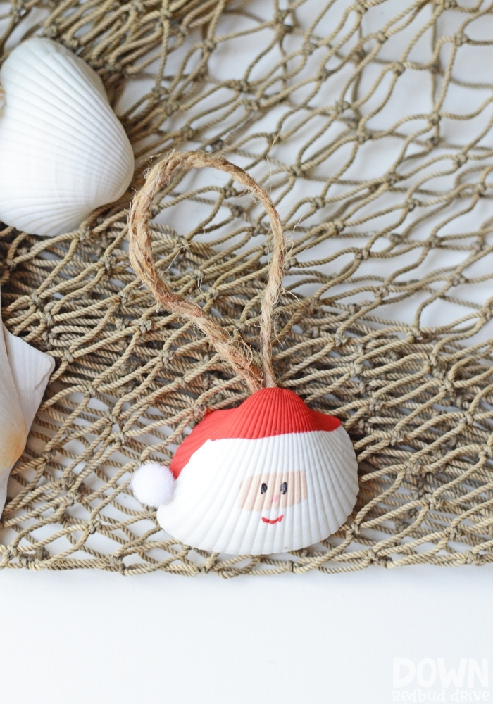 santa-seashell-ornament-diy-main-tall-4 Tall picture of a Santa Seashell Ornament on a fishing net.