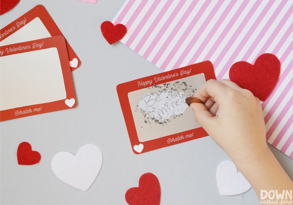 scratch-off-valentines-wide-6 A kid scratching a valentine that says "Be mine!"