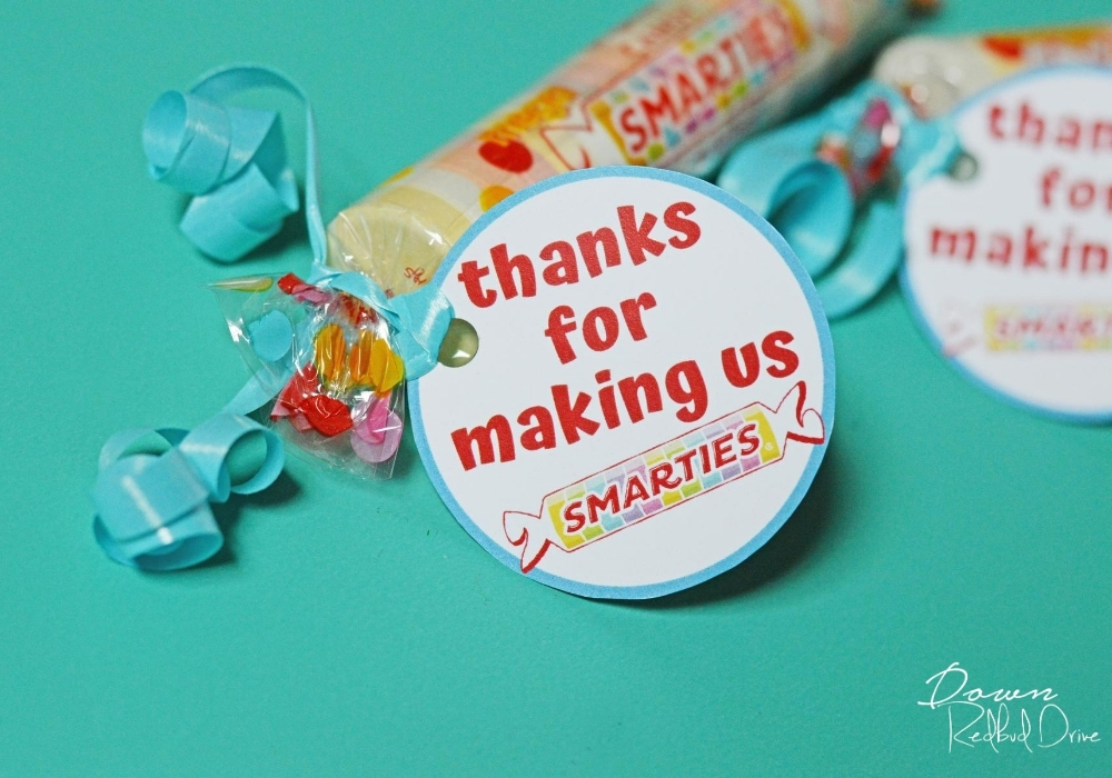smarties-teacher-gift-wide-2 Side shot of "thanks for making us smarties" tag attached to Smarties candy with a blue ribbon.