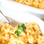 easy-healthy-hidden-veggie-mac-and-cheese-recipe-creamy-high-protein-vegetable-packed-butternut-squash-cottage-cheese-kid-friendly-150x150-1 Finished hidden veggie mac & cheese in a white bowl with a sprig of parsley on the top. More mac & cheese in the background. a text overlay reads the best ever hidden veggie macaroni and cheese husband and kid approved