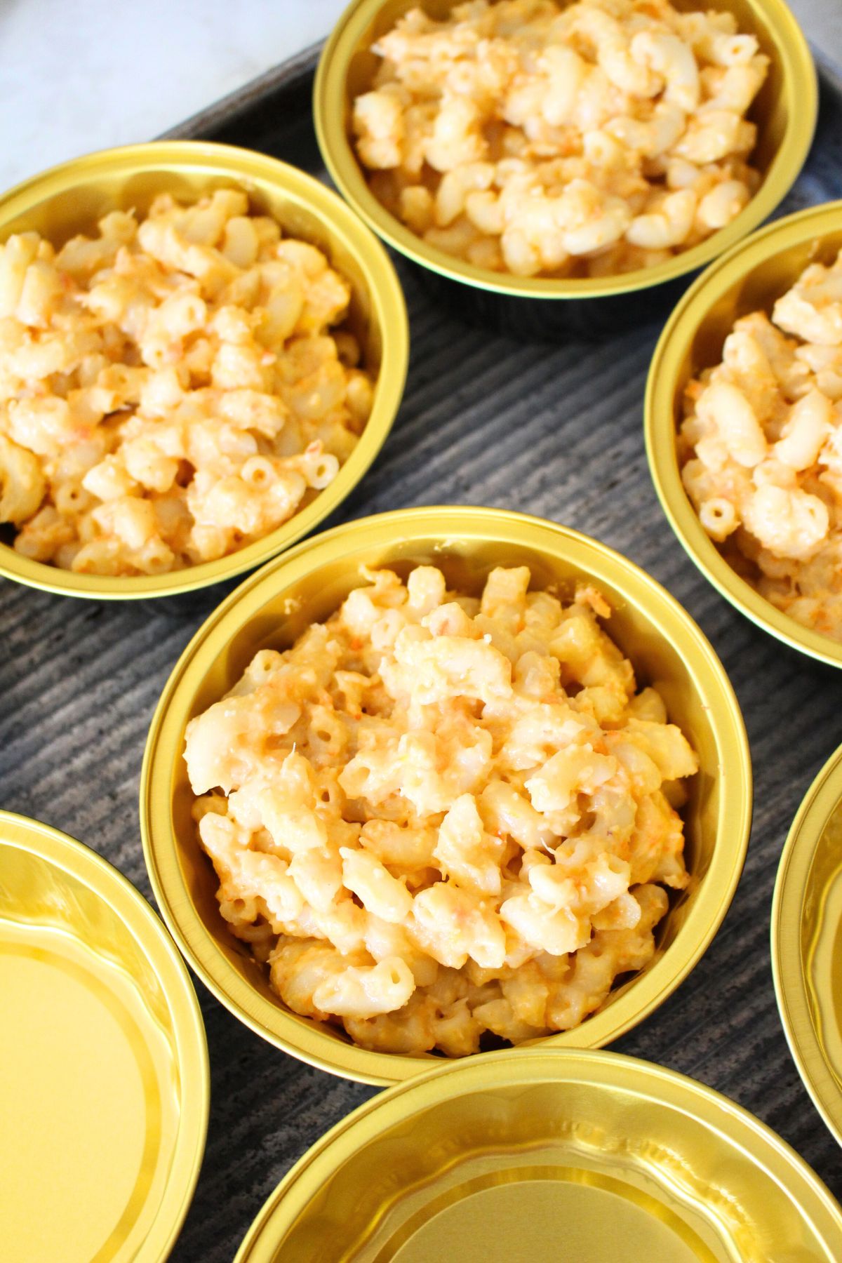 hidden-veggie-mac-and-cheese-recipe-freezing-instructions portioned mac and cheese in metal containers ready to freeze.